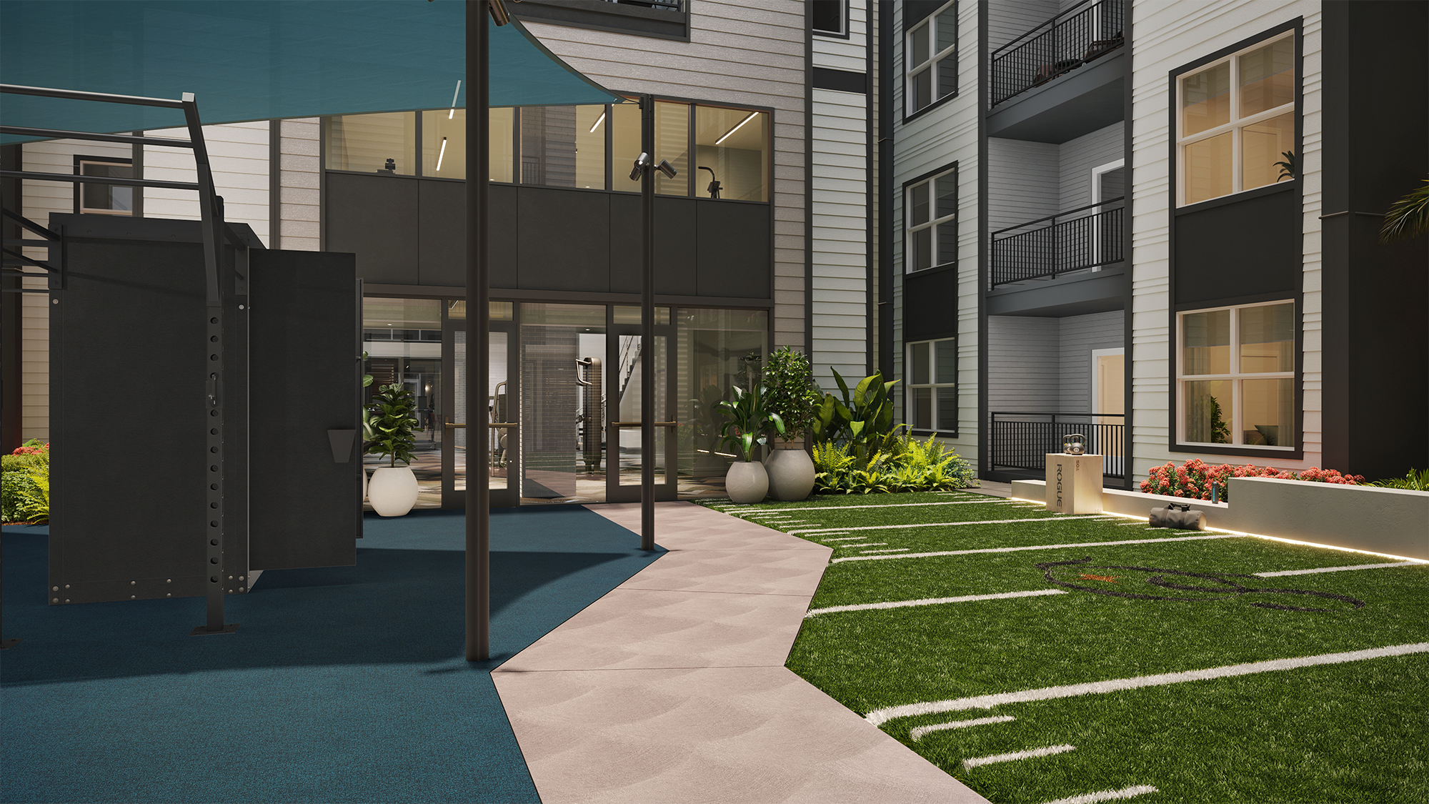 Sterling Quadrangle Outdoor courtyard at an apartment complex featuring an exercise area with a turf lawn and a blue sun shade.